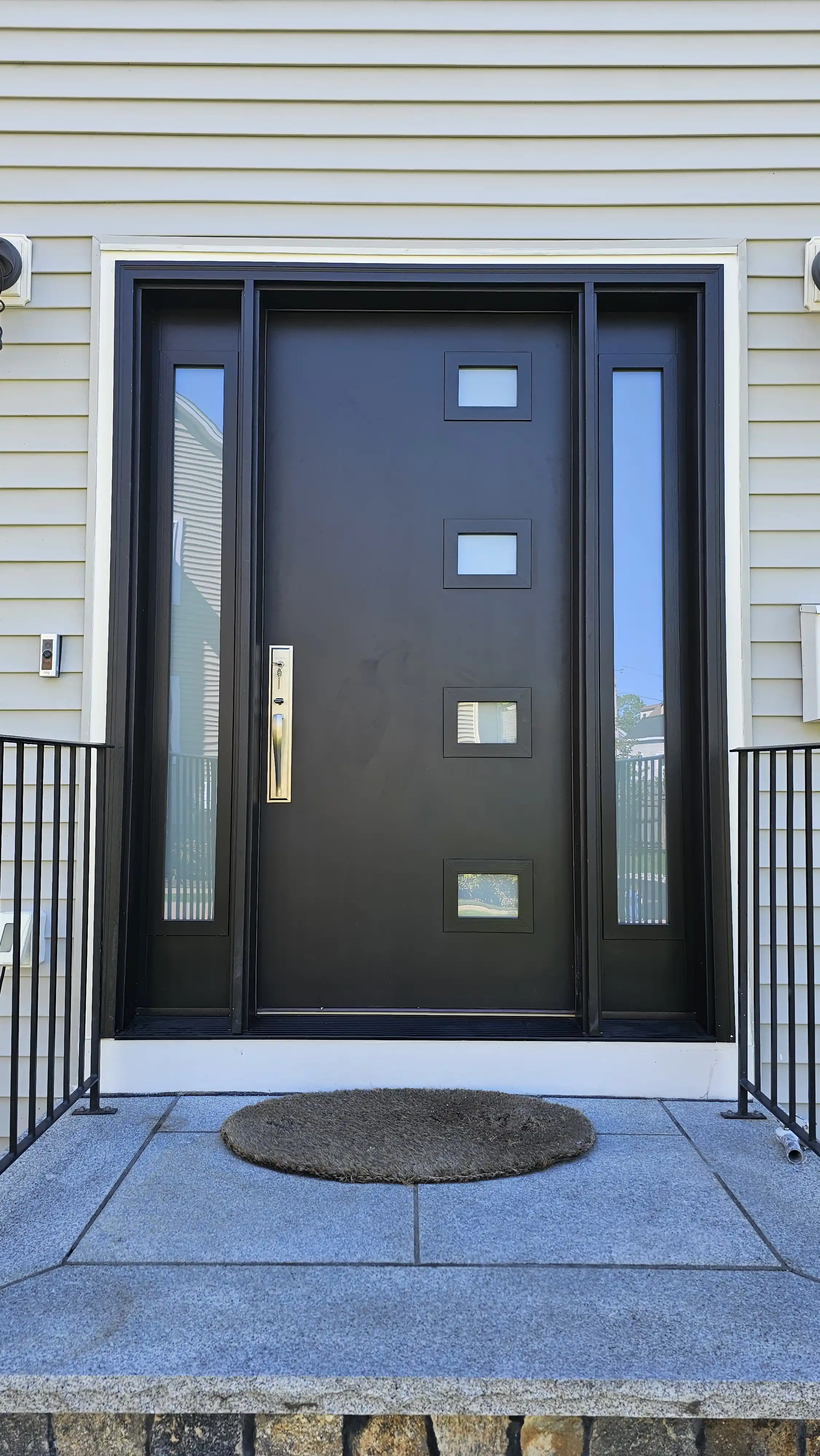 Modern black door with four square glass inserts and two sidelites
