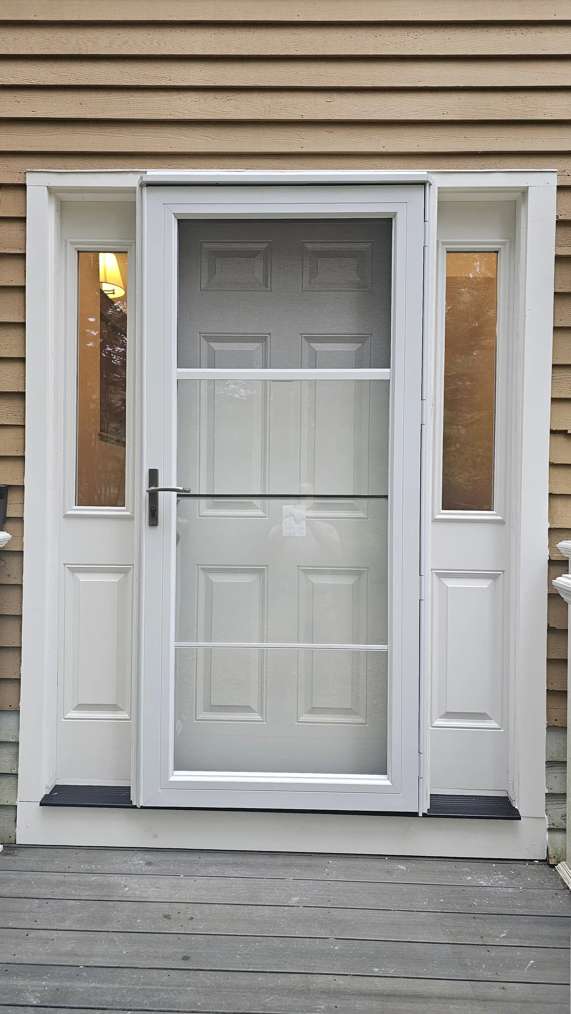 Traditional white door with a storm door and two glass sidelites