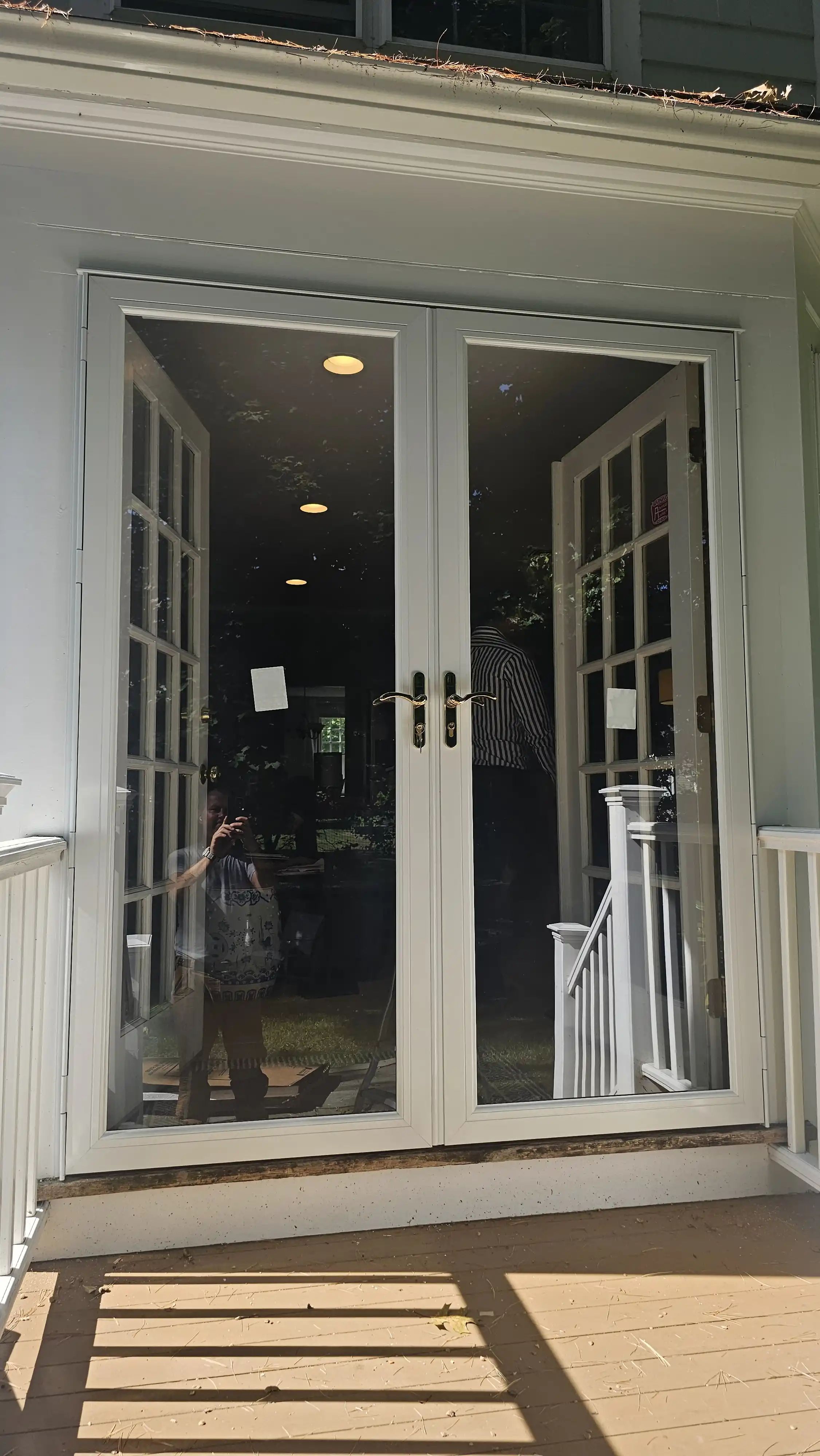 Exterior white storm doors with glass panels and classic frame design