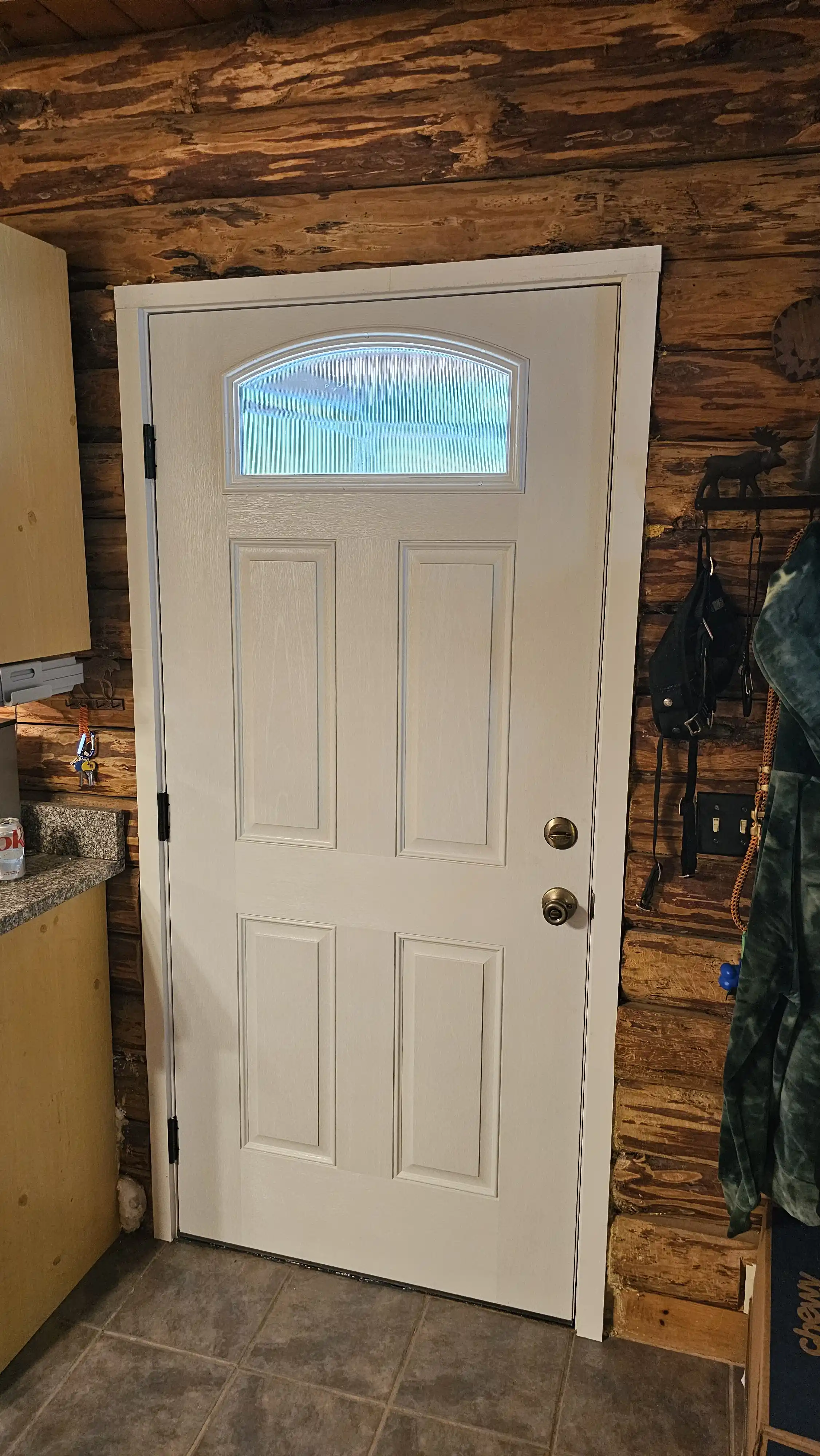 White entry door with arched glass panel and six raised panels