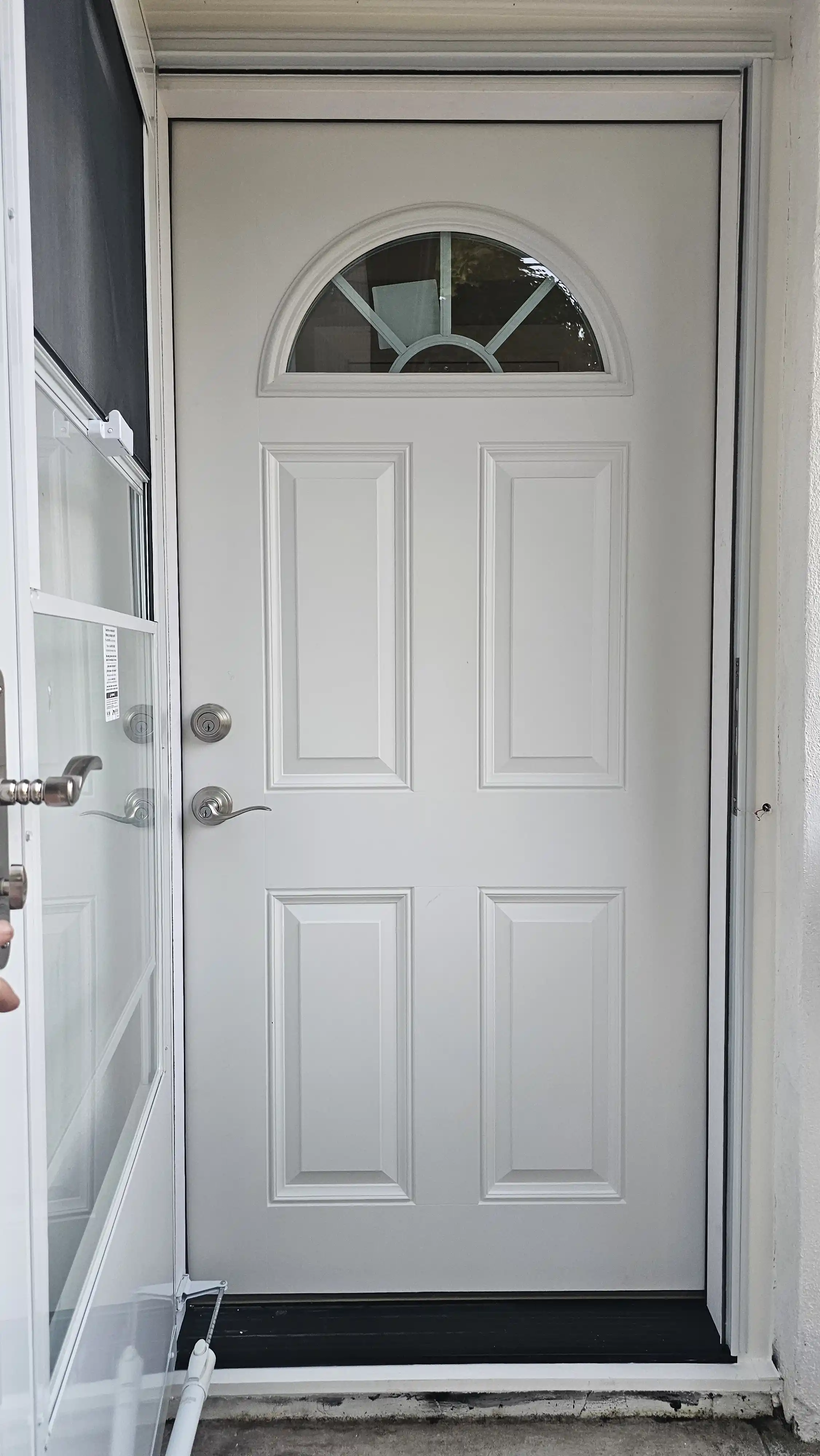 White entry door with half-moon glass panel and classic six-panel design