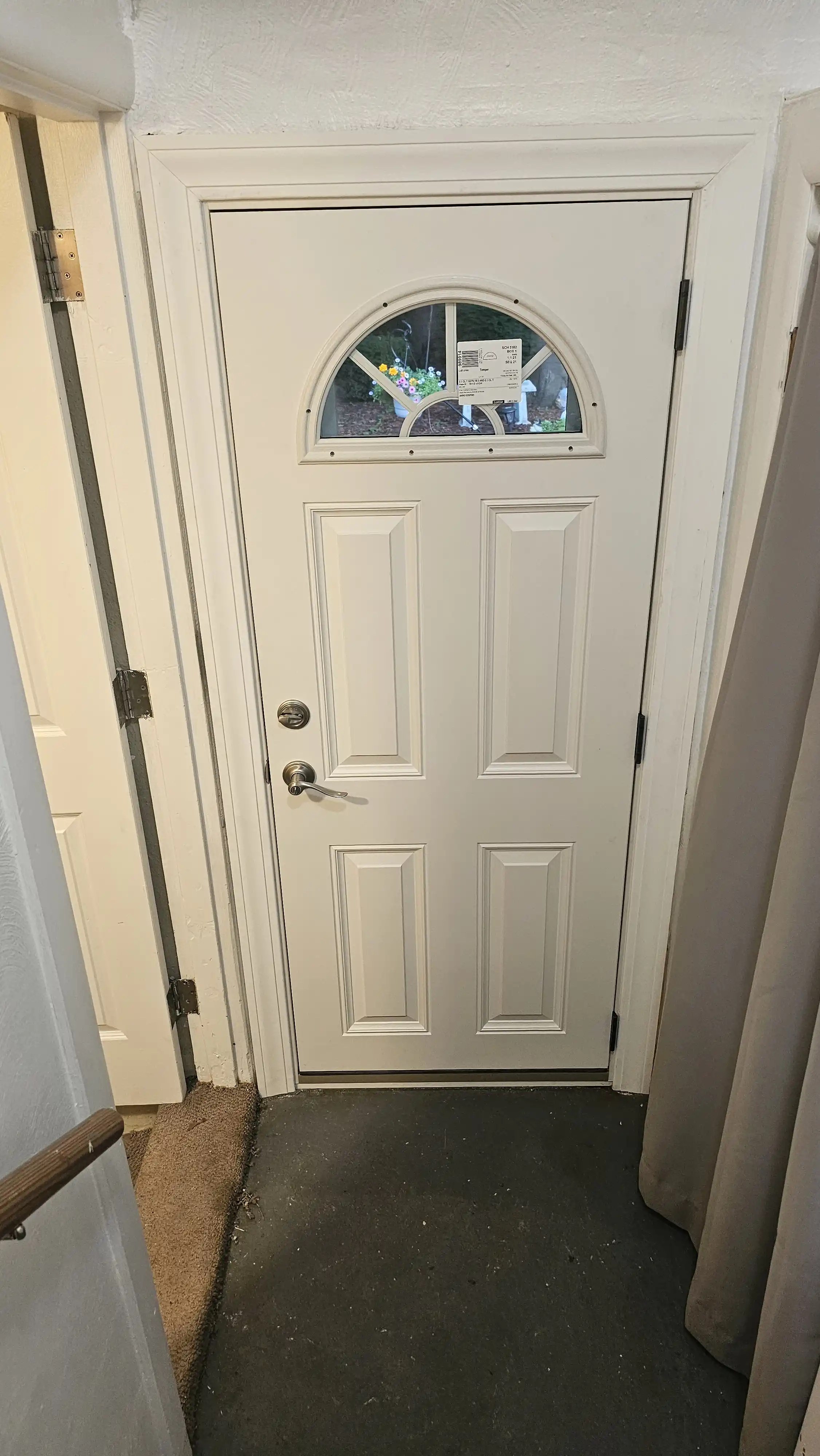 White entry door with arched glass and four rectangular panels