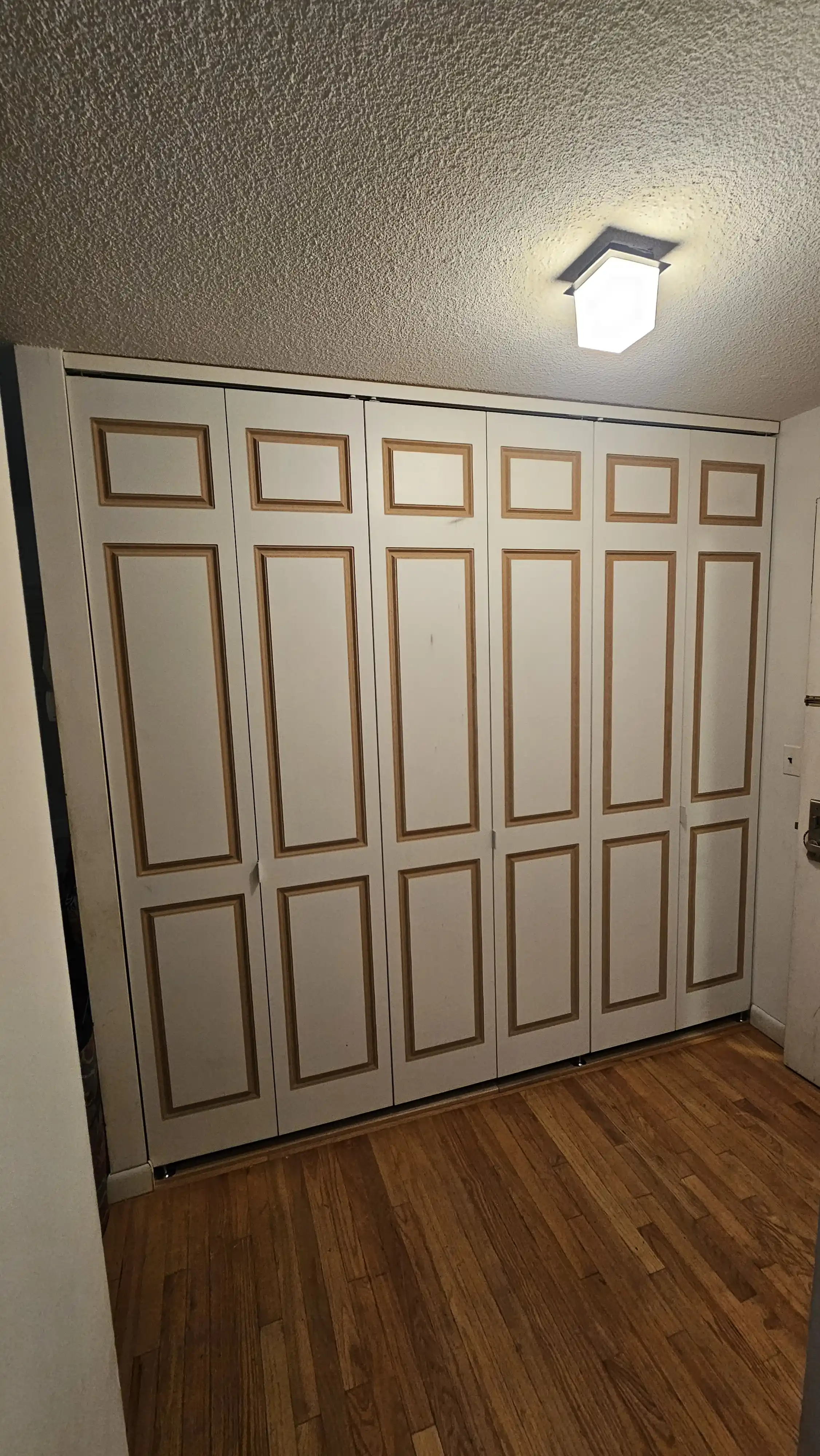 Four-section bi-fold doors with decorative brown trim outlining each panel