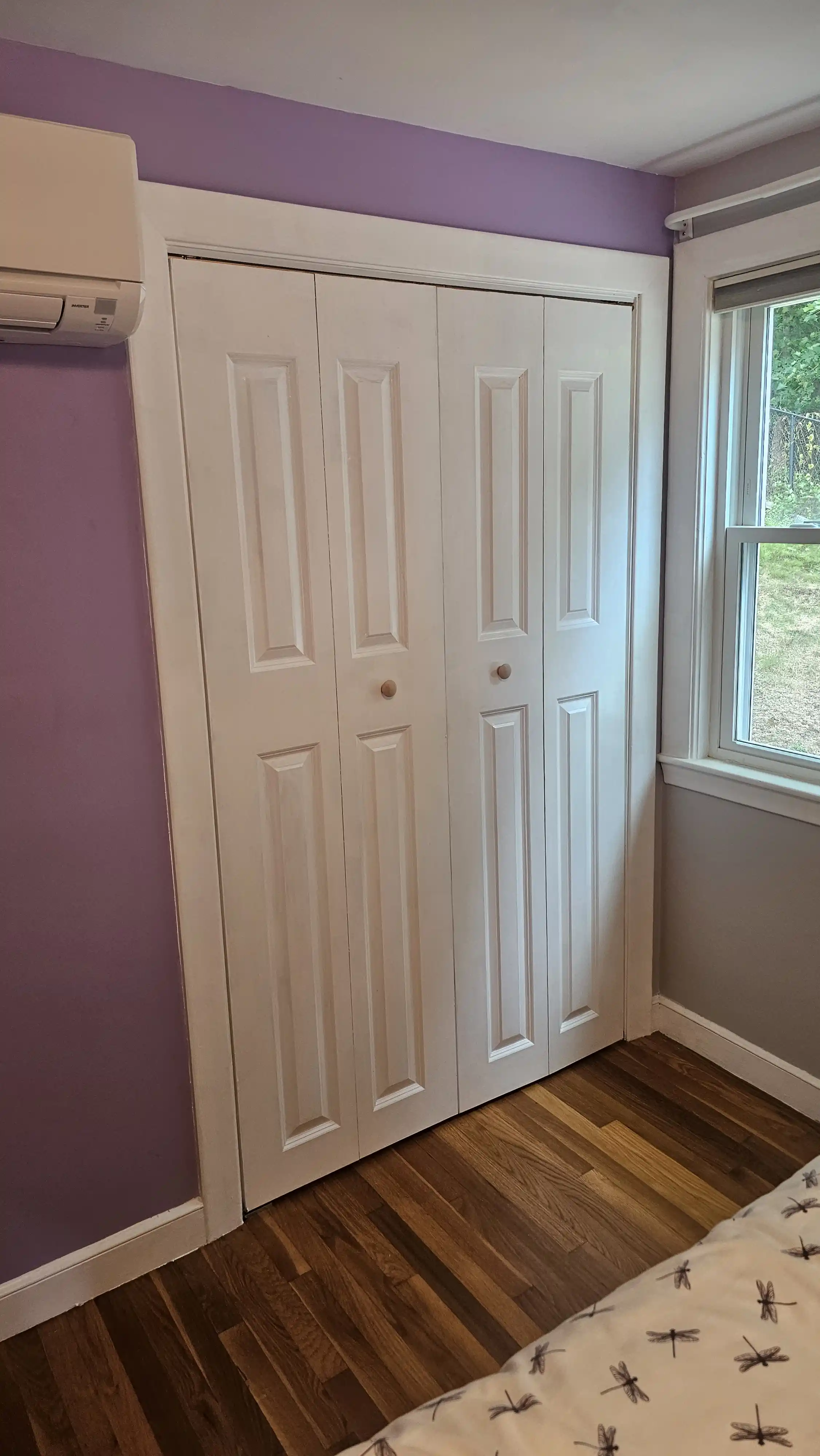 White double bi-fold doors with six square recessed panels per section, minimal hardware