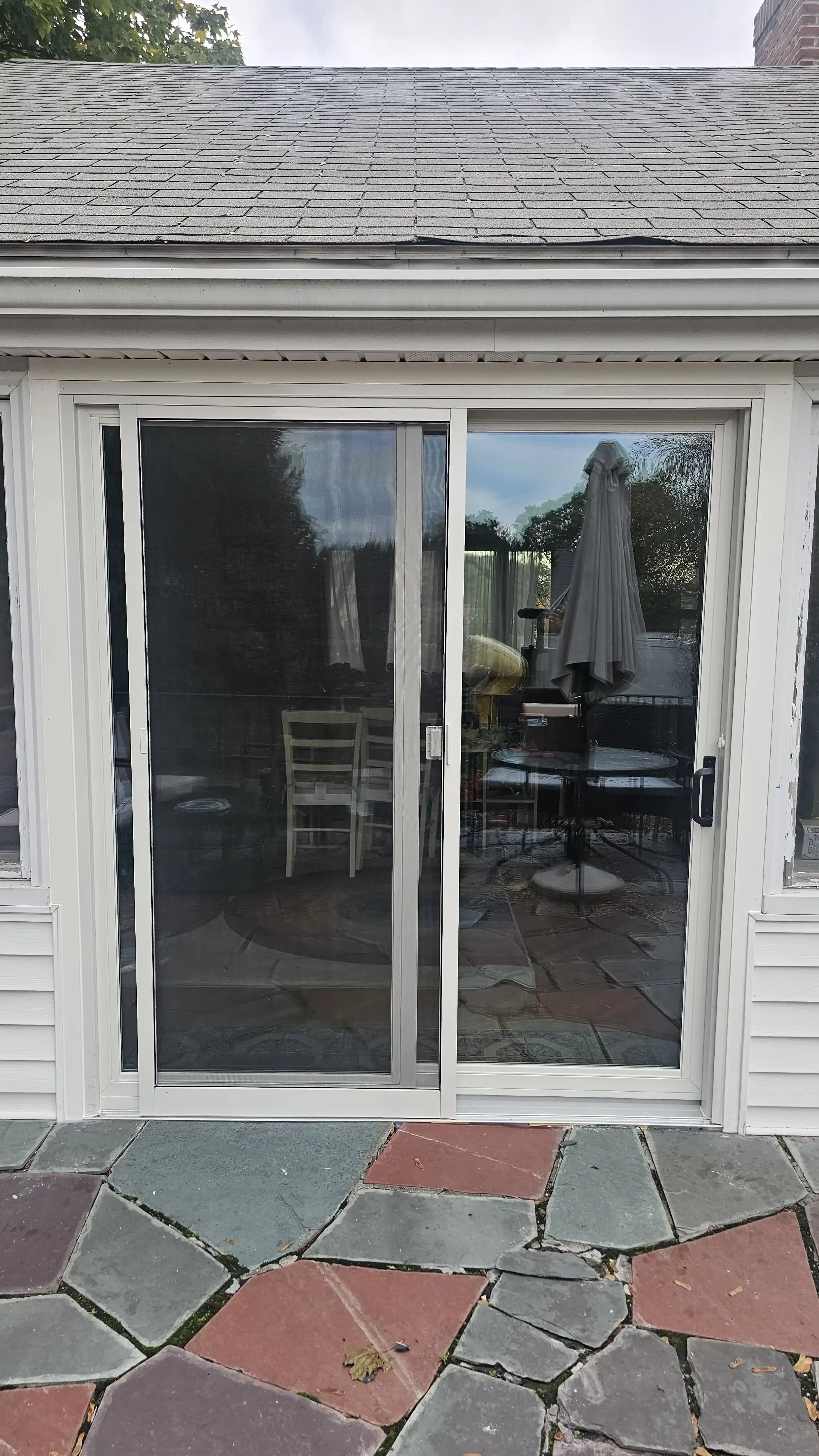 White aluminum sliding patio doors with a built-in screen panel