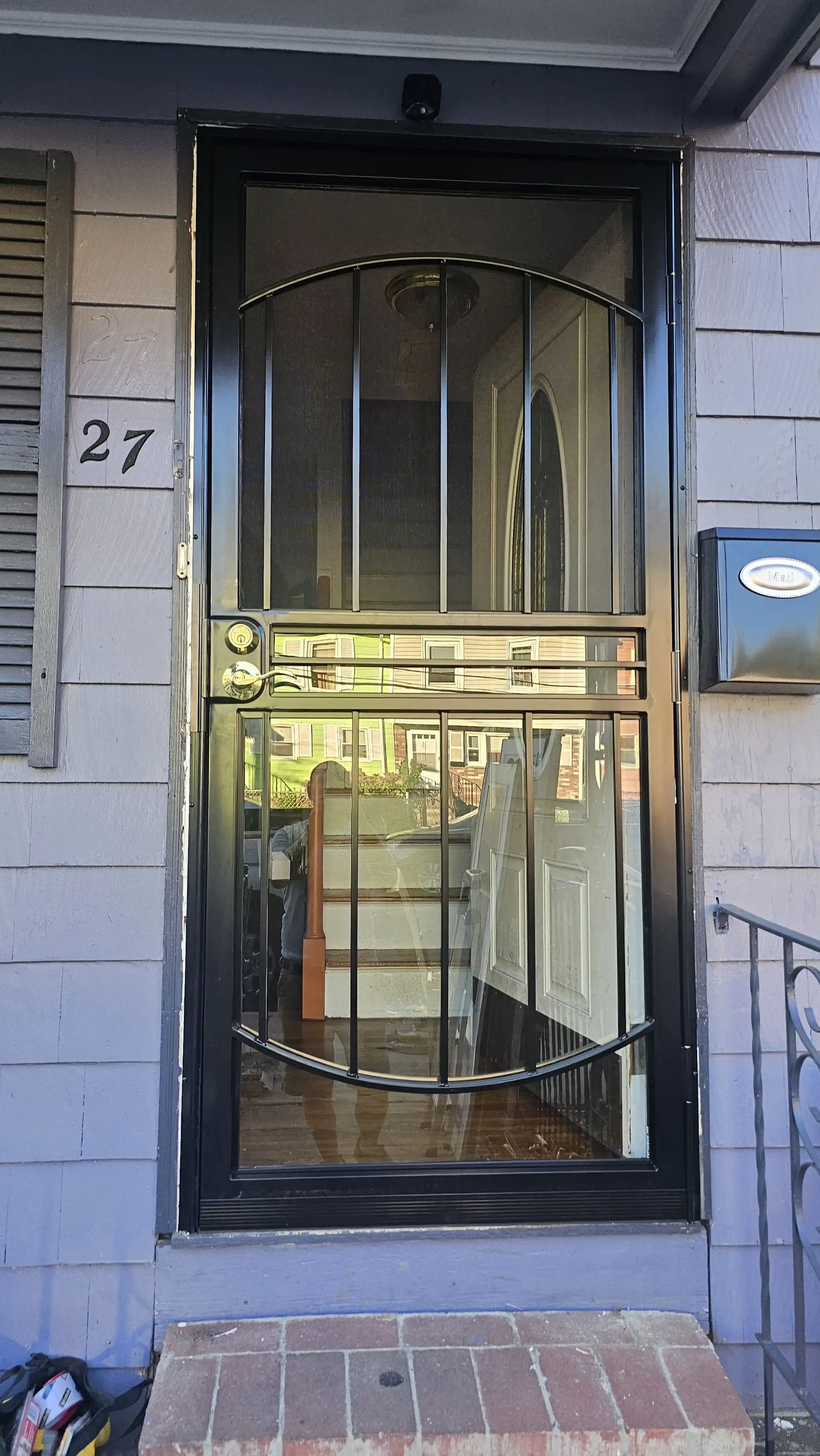 Reinforced security door with black metal frame and dual locks
