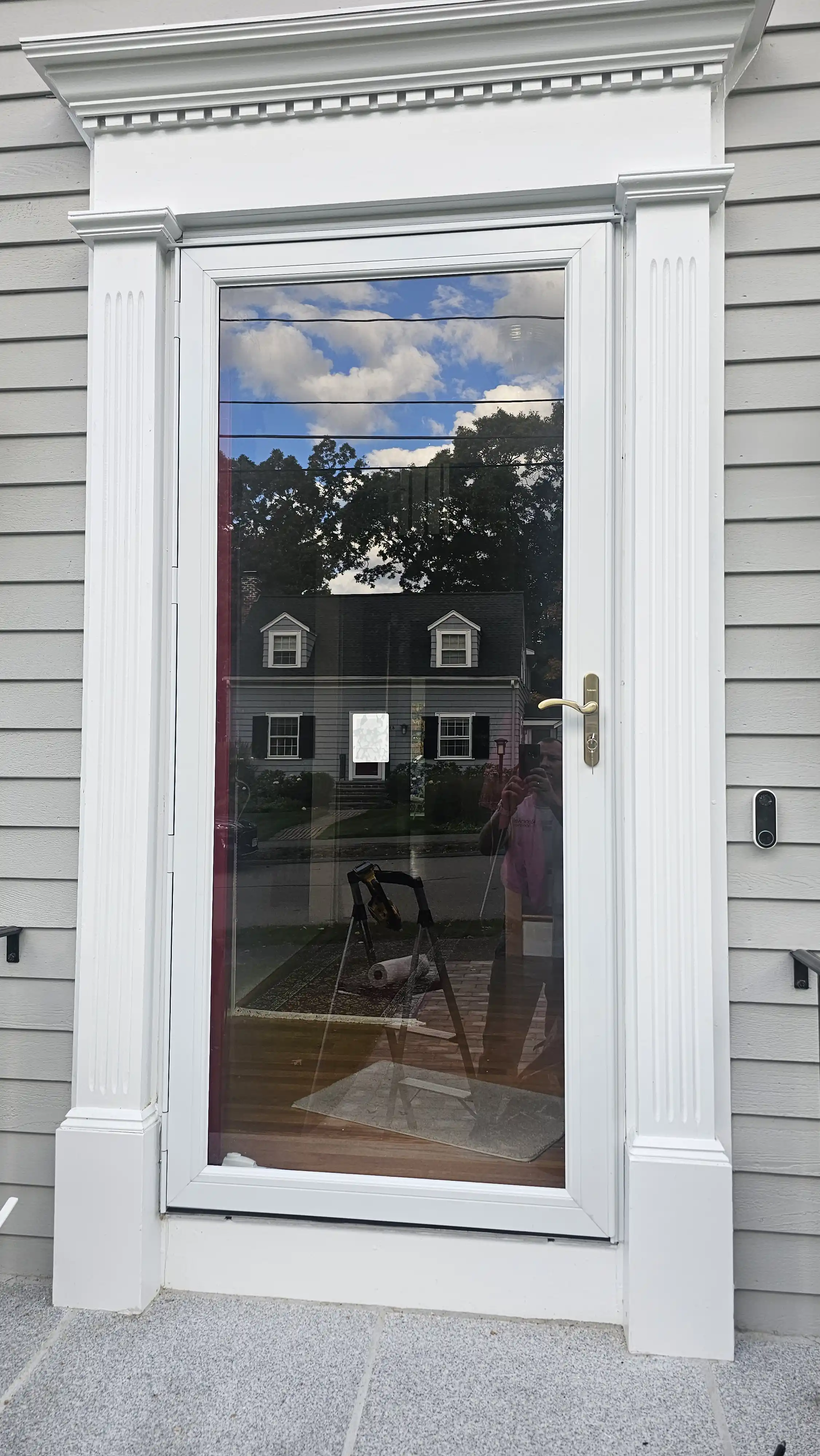 White storm door with a large screen panel and lower panel.