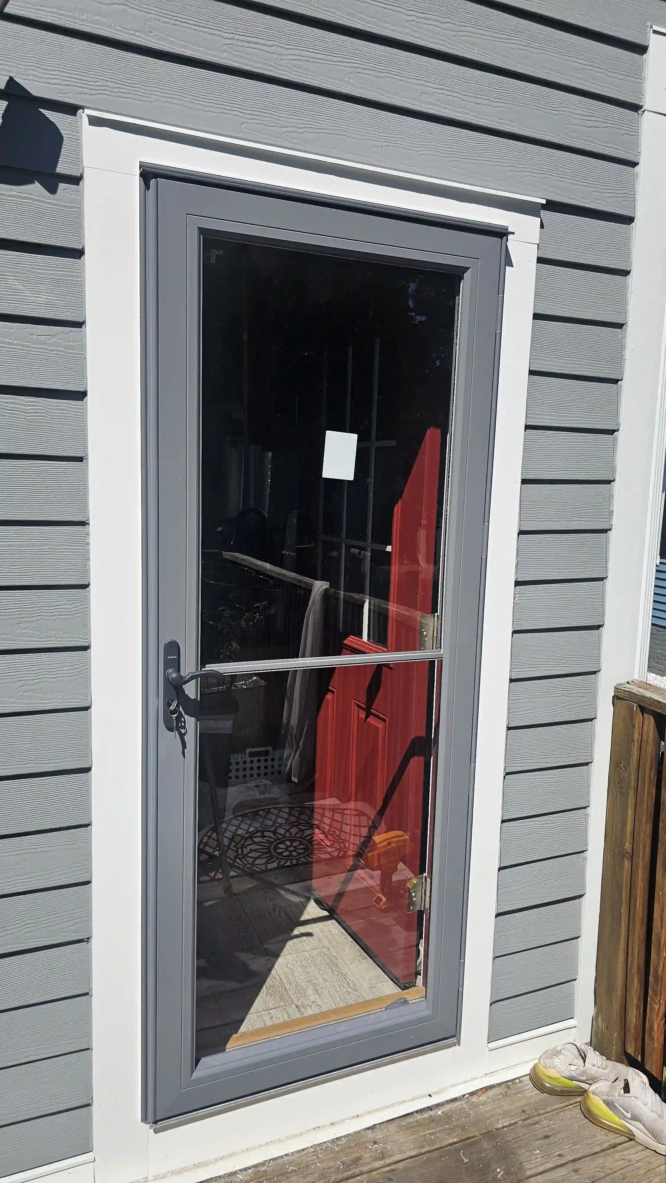 White storm door with a lower panel and removable screen.