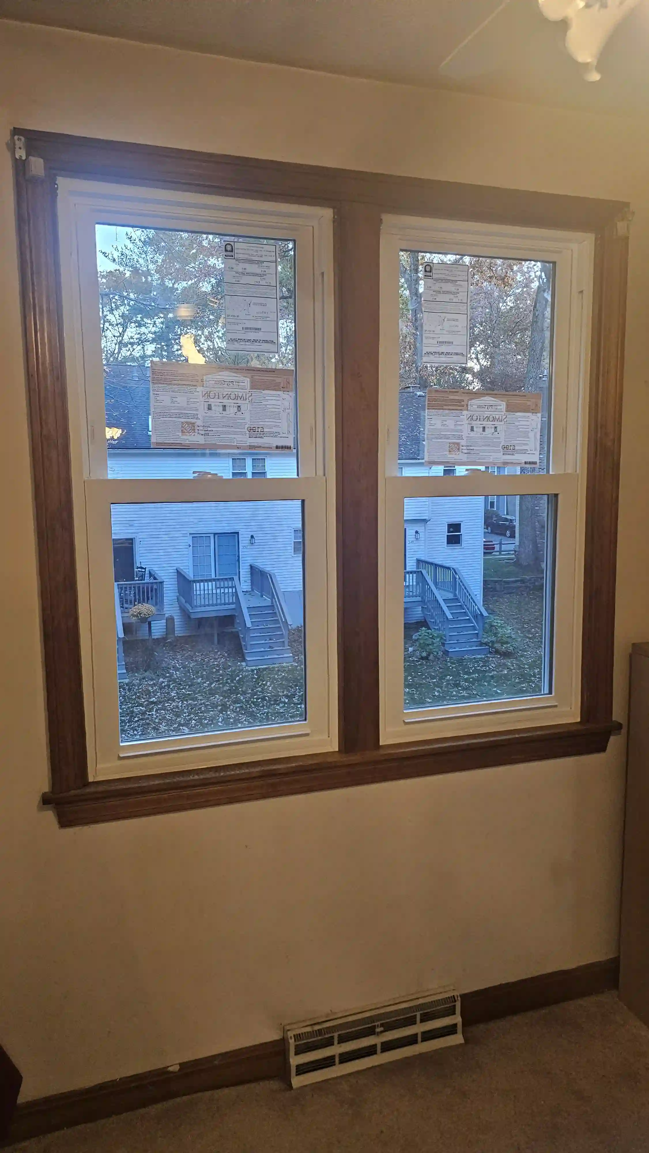 Housefront with multiple newly installed windows, including an arched top window above the entrance.